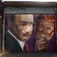 A mural depicting a winking Vladimir Putin taking off his Donald Trump mask is painted on a storefront outside a bar called Levee in Brooklyn, N.Y., on Feb. 25, 2017. (Spencer Platt/Getty Images)